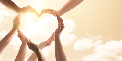 3 a group of hands workign together to form a heart shape